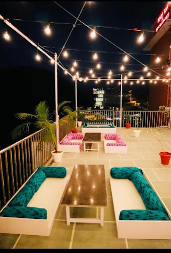 Rooftop lounge seating with string lights